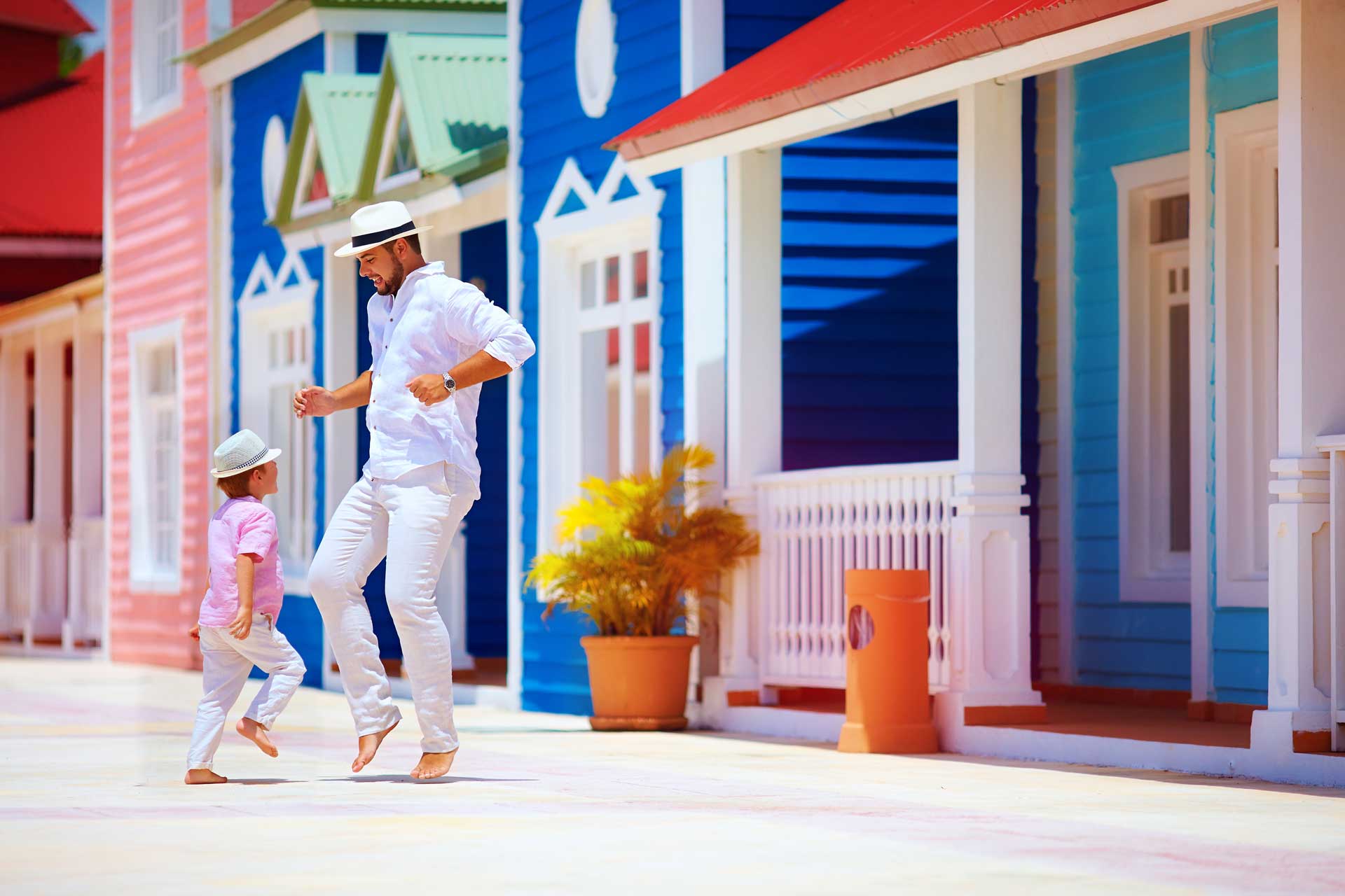 happy father and son enjoy life, dancing on caribbean street