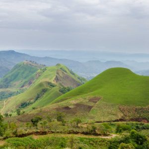 Rolling fertile hills with fields and crops on Ring Road of Cameroon, Africa